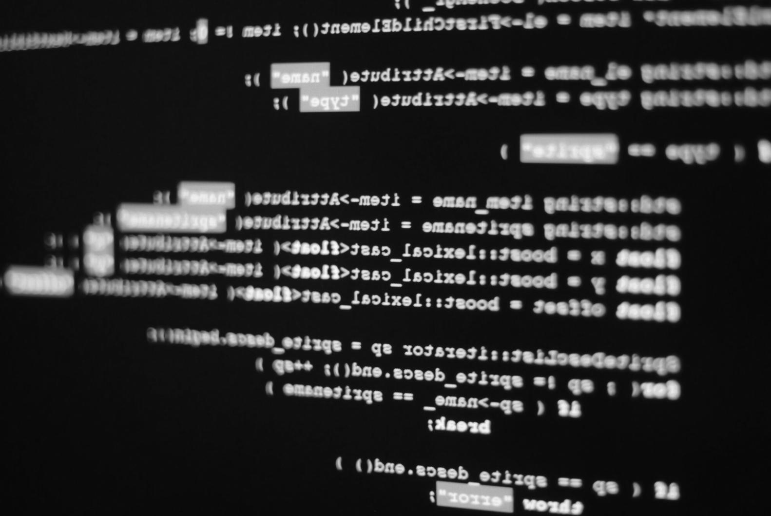 Mobile app development workspace showing code editor and smartphone testing